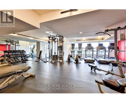 A gym with a variety of equipment including treadmills, weights, and exercise machines.