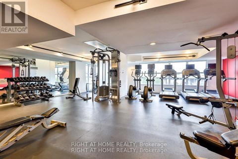 A gym with a variety of equipment including treadmills, weights, and exercise machines.