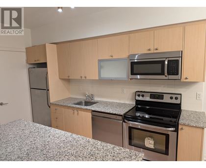 A kitchen with a stove, microwave, and refrigerator.