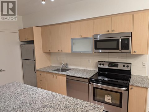 A kitchen with a stove, microwave, and refrigerator.
