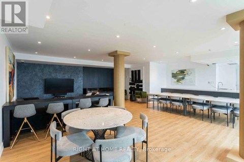 A modern dining room with a round table and chairs.