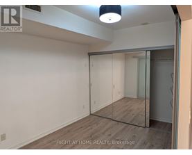 A room with a sliding glass door and a wooden floor.