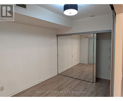 A room with a sliding glass door and a wooden floor.