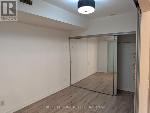 A room with a sliding glass door and a wooden floor.