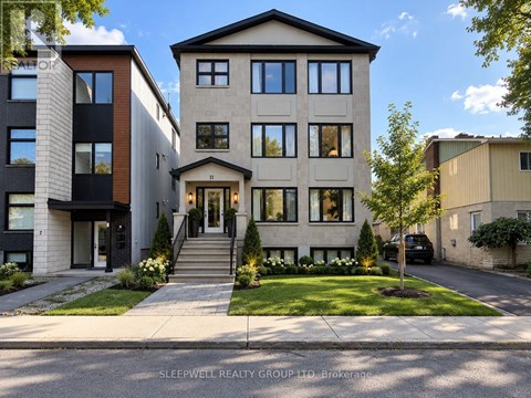 A modern two-story house with a front yard and a car parked in the driveway.