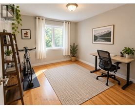 A room with a desk, chair, and bicycle.