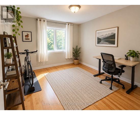 A room with a desk, chair, and bicycle.