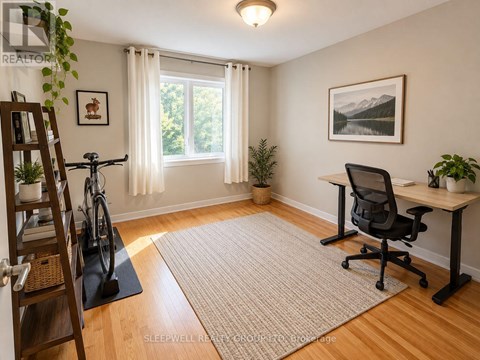 A room with a desk, chair, and bicycle.