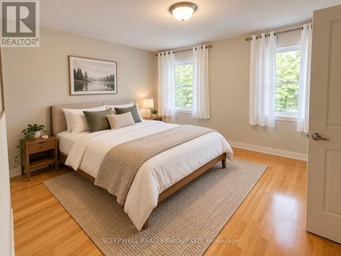 A bedroom with a large bed and a painting on the wall.