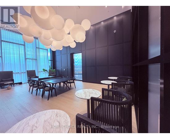 A modern dining room with a long table and chairs.