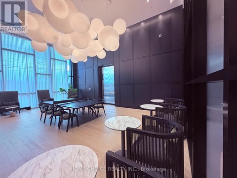 A modern dining room with a long table and chairs.