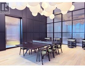 A dining room with a long table and chairs.