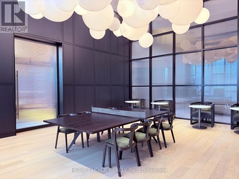 A dining room with a long table and chairs.