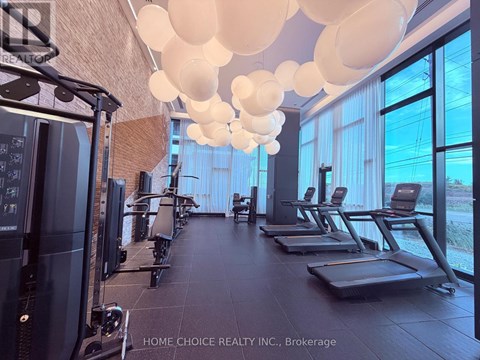 A gym with treadmills, elliptical machines, and a rowing machine.