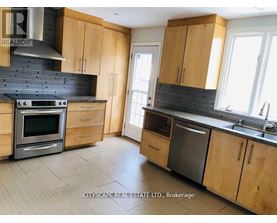 A kitchen with wooden cabinets and a black stove top oven.