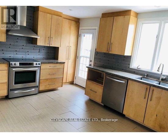 A kitchen with wooden cabinets and a black stove top oven.