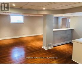 A room with wooden floors and a large window.