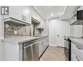 A kitchen with white cabinets and a tile backsplash.