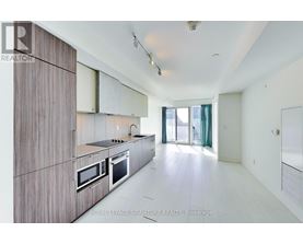 A modern kitchen with wooden cabinets and stainless steel appliances.