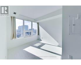A white room with a window overlooking a cityscape.