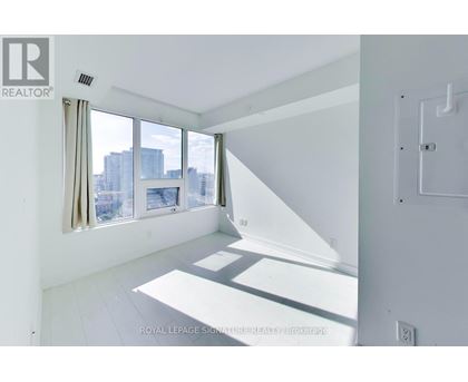 A white room with a window overlooking a cityscape.