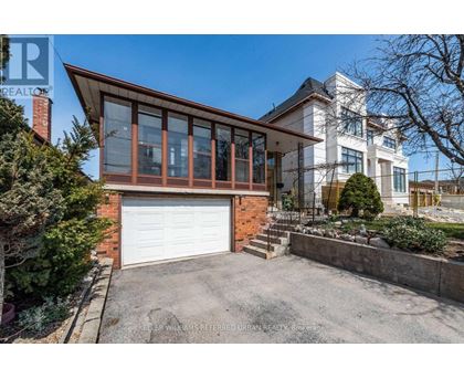 A house with a white garage door and a brick chimney.