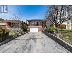 A house with a driveway in front of it.