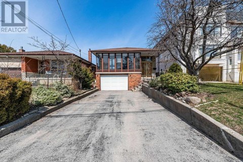 A house with a driveway in front of it.