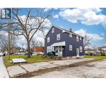 A blue house with a tree in front of it.