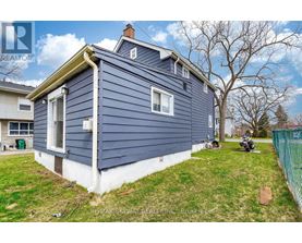 A blue house with a white trim is for sale.