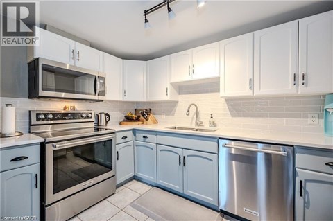 A kitchen with white cabinets and stainless steel appliances.