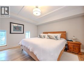 A bedroom with a large bed and a wooden headboard.
