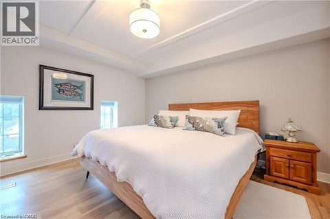 A bedroom with a large bed and a wooden headboard.