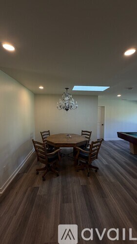A dining room with a wooden table and chairs.