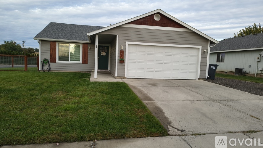 A house with a garage and a driveway in front.