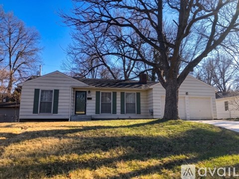 A house with a tree in front of it.