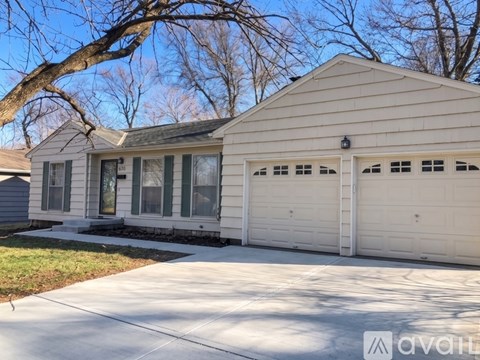 A house with a white garage door is for sale.