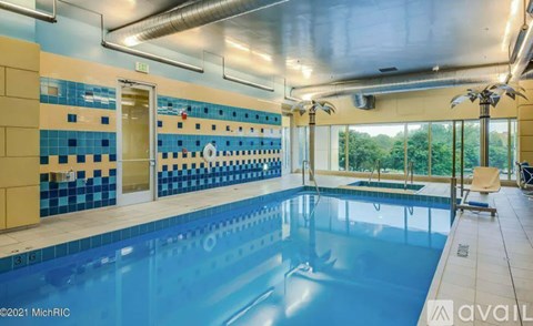 A large indoor swimming pool with blue tiles on the walls.