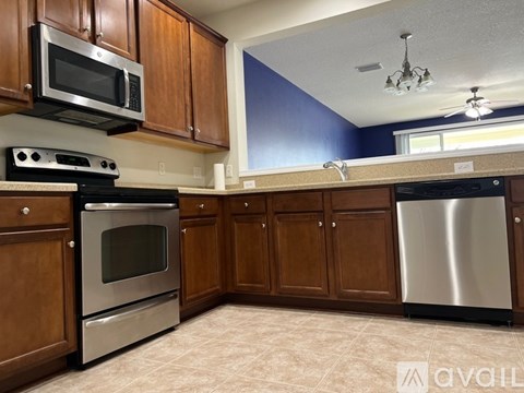 A kitchen with wooden cabinets and stainless steel appliances.
