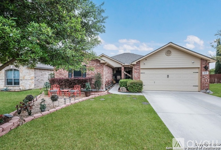A house with a garage and a driveway in front of it.