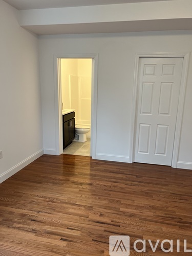A room with wooden floors and a white door.