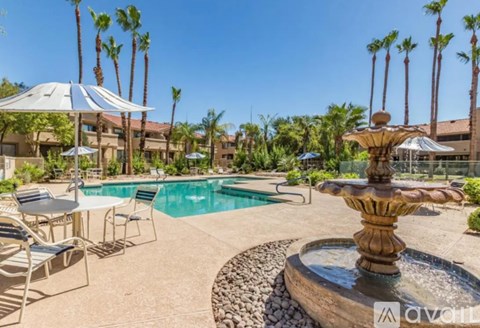 A pool with a fountain in the middle of it.