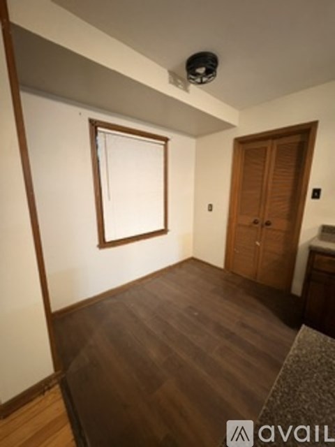 A room with a wooden floor and a window.