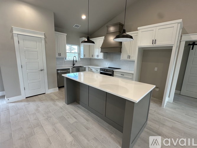 A kitchen with a large island in the middle.
