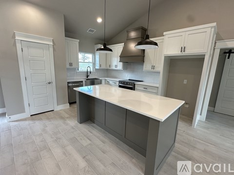 A kitchen with a large island in the middle.