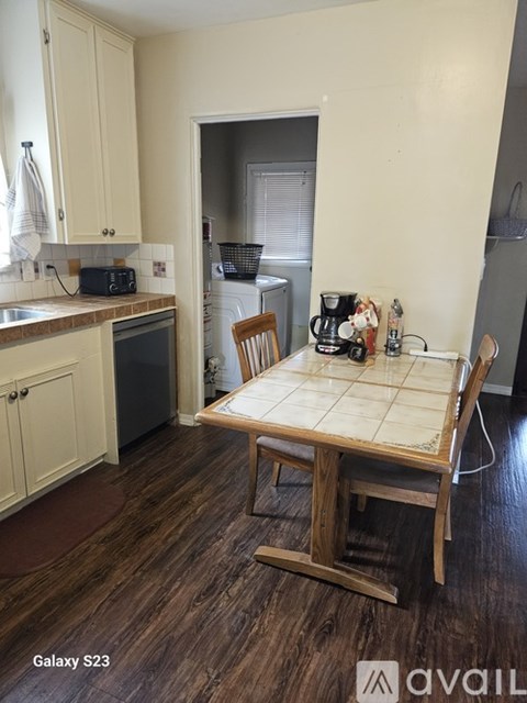 A kitchen with a table and chairs in the middle of the room.