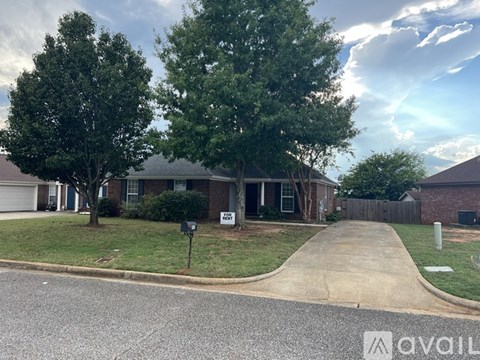A house with a driveway and a mailbox in front.