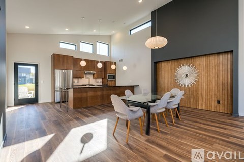 A modern kitchen with a dining table set up.