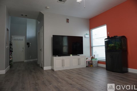 A living room with a television and a cabinet.
