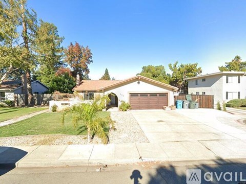 A house with a driveway and a garage is for sale.
